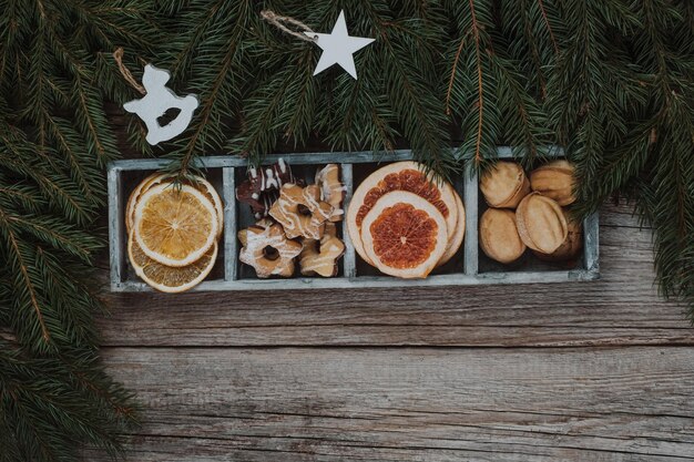 Christmas cookies in the box and festive decor on a wooden background Merry Christmas and Happy New