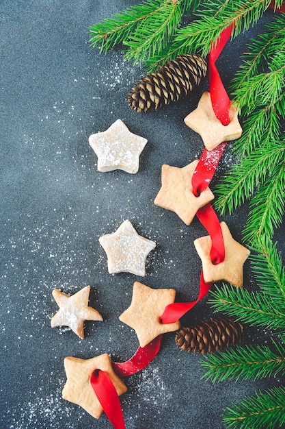 Christmas cookies decorated with a red ribbon with a bow and a small twig 