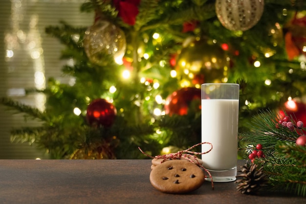 Christmas cookies and milk for Santa near Xmas tree