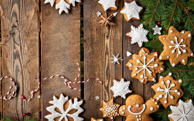 Christmas cookies and tinsel on a wooden background