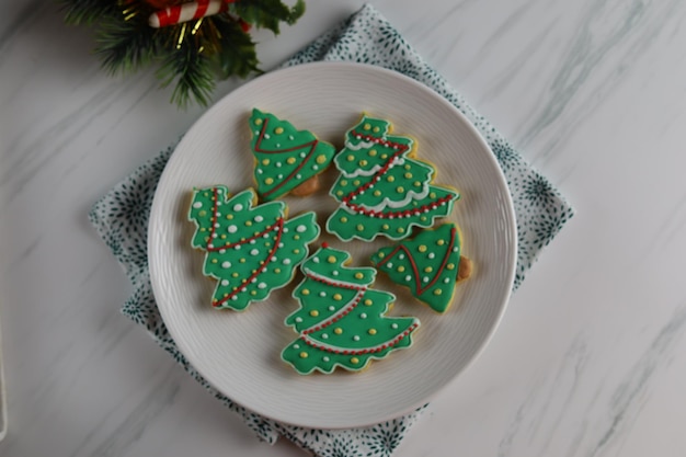 Christmas cookies with Christmas tree shape served in white plate with white background