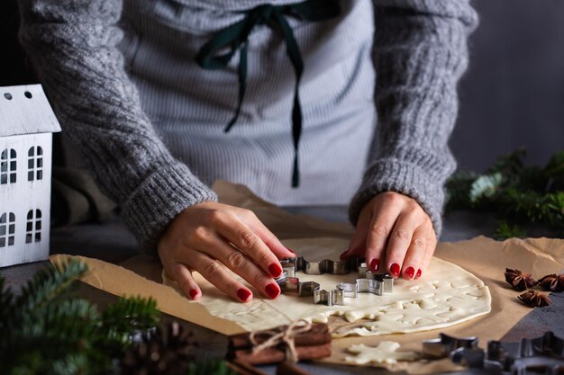 Christmas cooking and baking female hands making cookies from dough