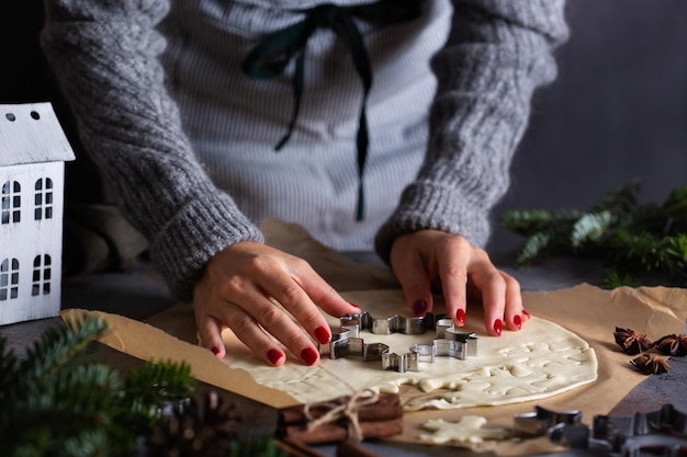 Christmas cooking and baking female hands making cookies from dough