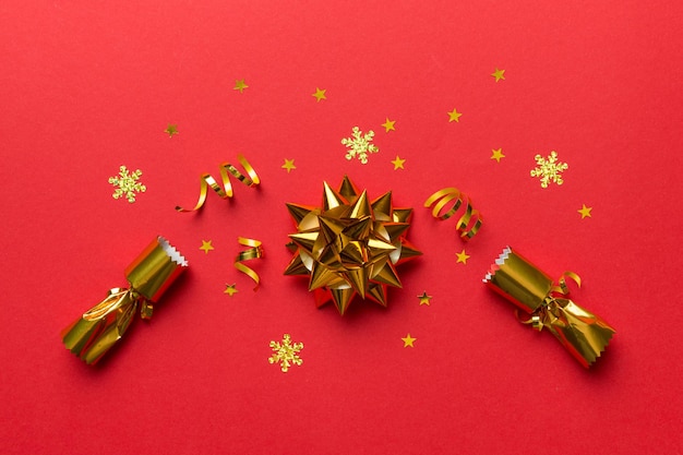 Christmas crackers with shiny confetti on color background, top view, copy space