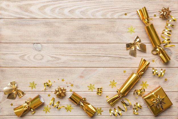 Christmas crackers with shiny confetti on color background, top view, copy space