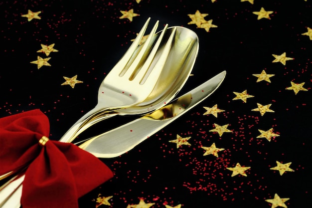 Christmas cutlery Spoon fork and knife stacked up on a starry background