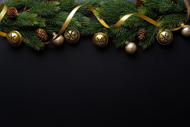 Christmas deco with fir and baubles on dark background. Flat Lay. Christmas concept