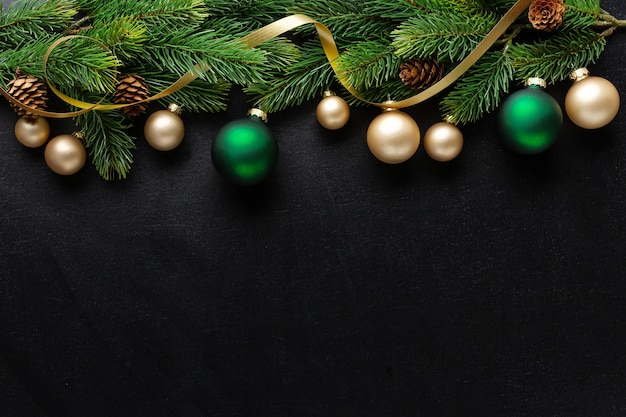 Christmas deco with fir and baubles on dark background. Flat Lay. Christmas concept