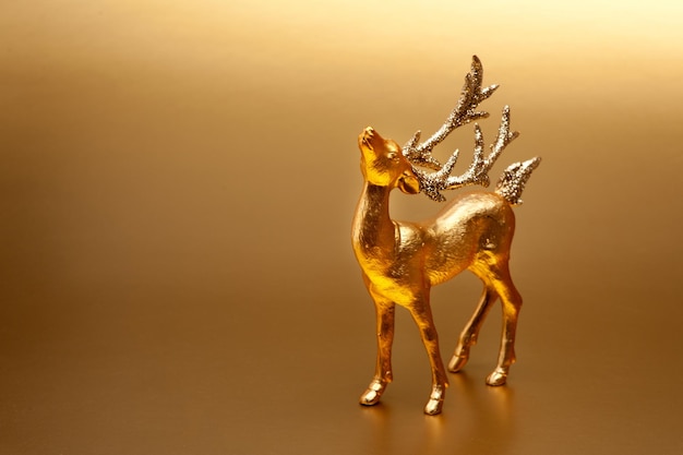 Christmas decor golden deer on background with bokeh