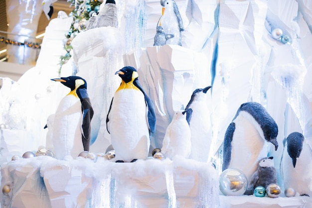 Christmas decor Ornamental penguins on an artificial iceberg made of snow and ice