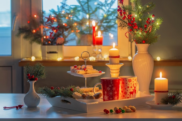 Christmas decor and red cups with hot drink on kitchen