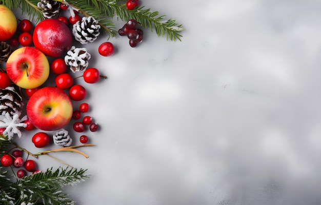 Christmas decor with berry tree branch apples and cones on grey snowy background top view