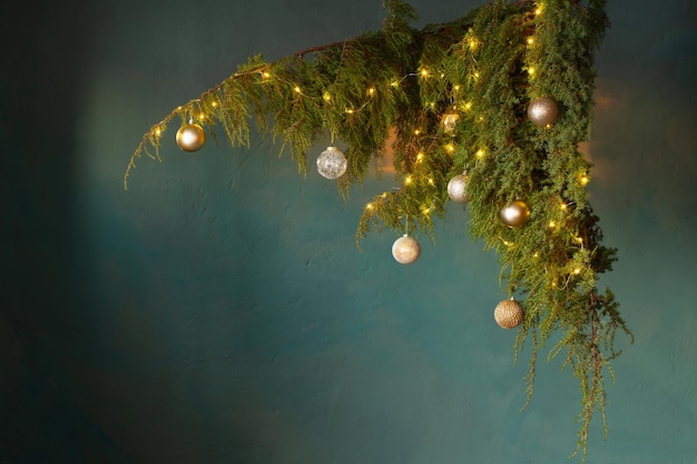 Christmas decor with golden balls on background dark wall