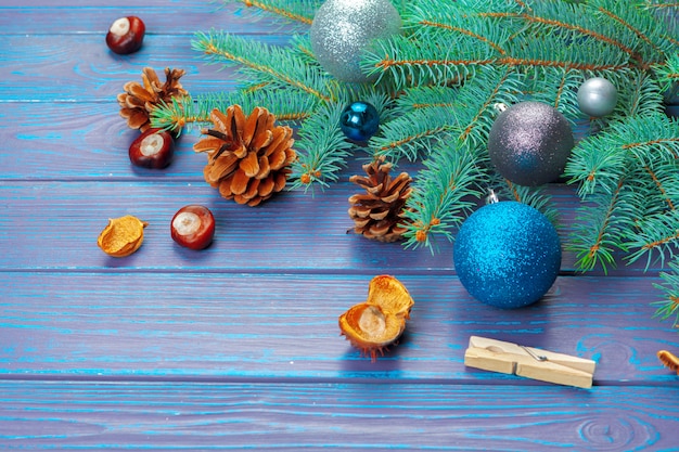 Christmas decoration, gift box and pine tree branches on wooden 