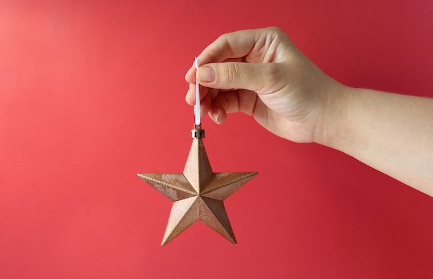 Christmas decoration holidays and people concept close up of woman hand holding christmas star