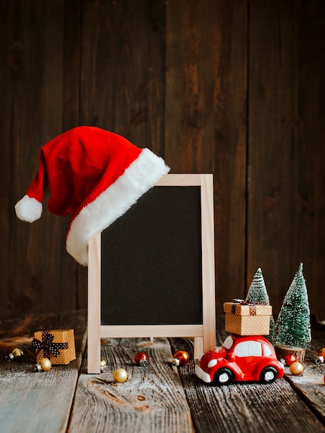 Christmas decoration with blank signboard and Santa Claus hat