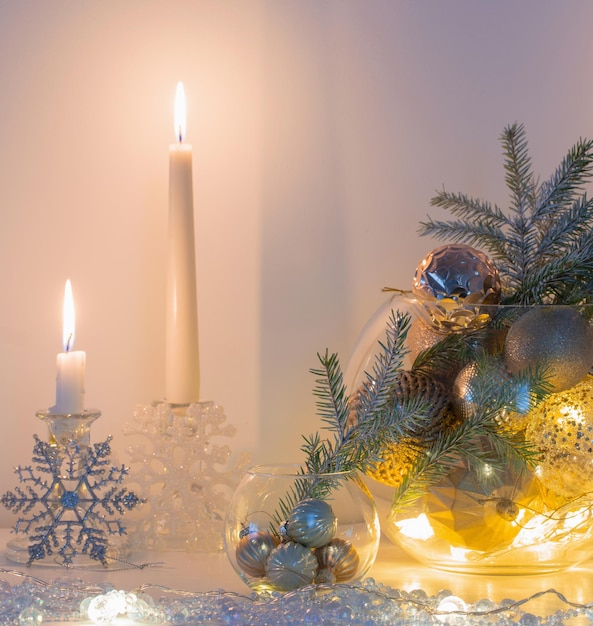 Christmas decoration with burning candles in white interior