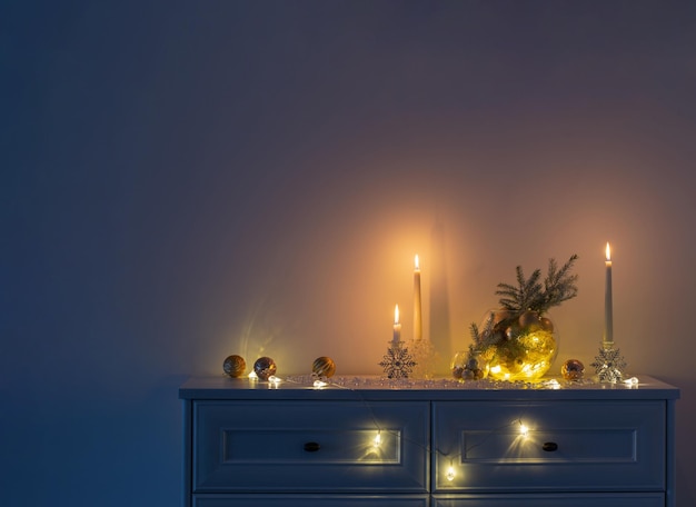 Christmas decoration with burning candles in white interior