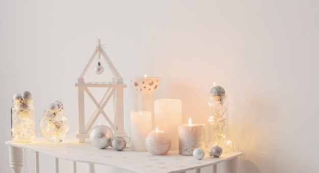 Christmas decoration with candles on background white wall