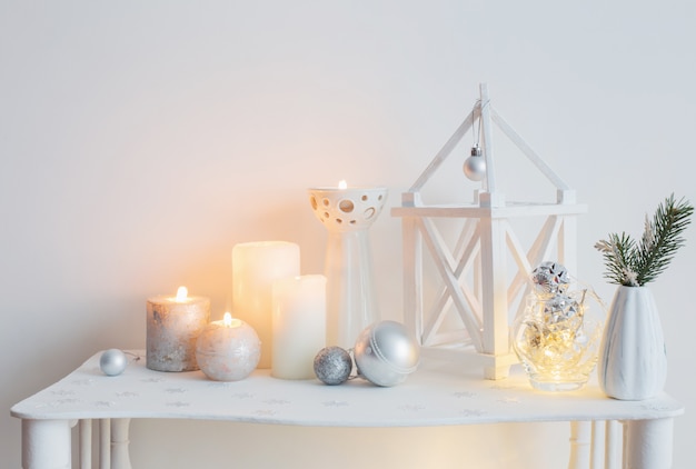 Christmas decoration with candles on background  white wall