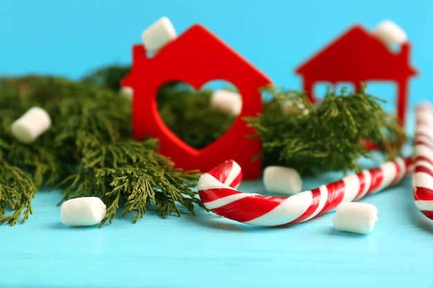 Christmas decoration with candy canes on blue wooden background