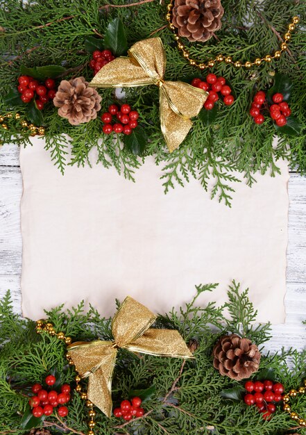 Christmas decoration with paper sheet on wooden background