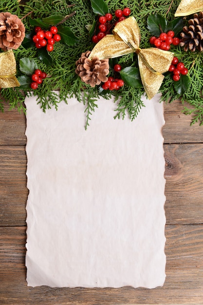 Christmas decoration with paper sheet on wooden background