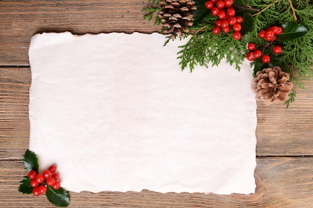 Christmas decoration with paper sheet on wooden background