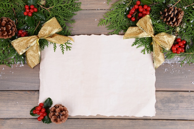 Christmas decoration with paper sheet on wooden surface