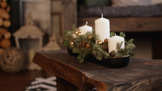 Christmas decoration on wooden table. Christmas white candles on a wooden table