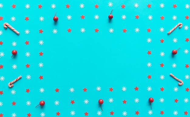 Christmas decorations on blue paper background with copyspace. Flat lay, top view