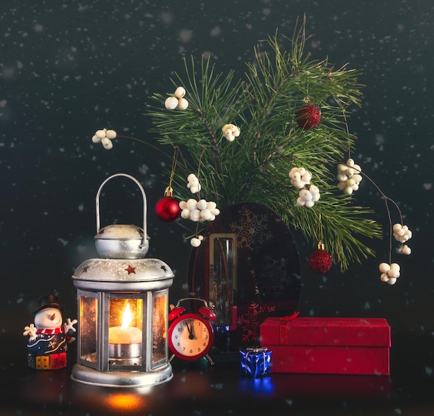 Christmas decorations and a burning candle in a lantern. New Year's still life