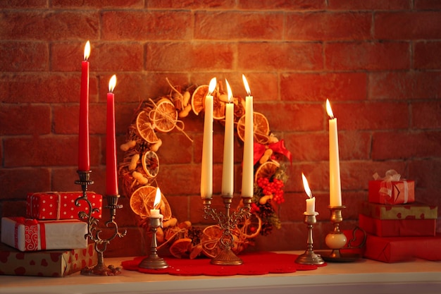 Christmas decorations and candles on mantelpiece