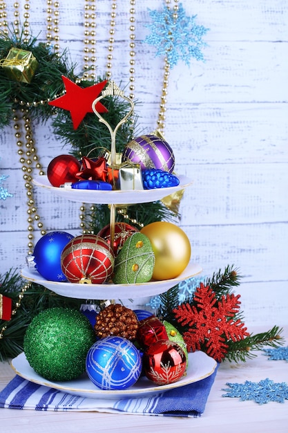 Christmas decorations on dessert stand, on  color wooden background