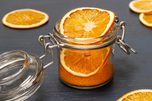 Christmas decorations dry orange slices in glass jar and on table