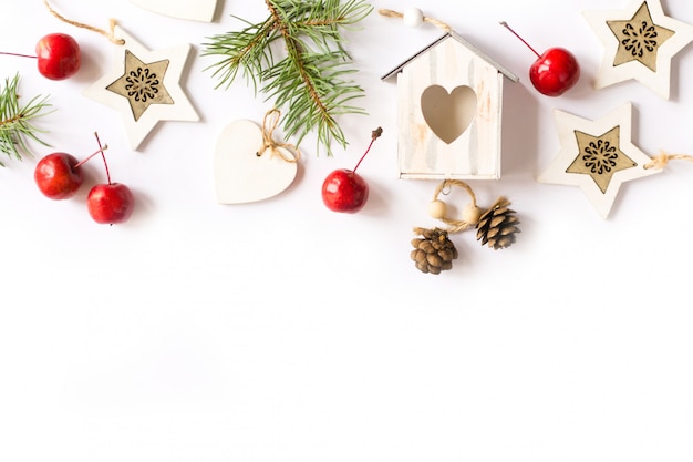 Christmas decorations, fir tree branches, red apples on white background