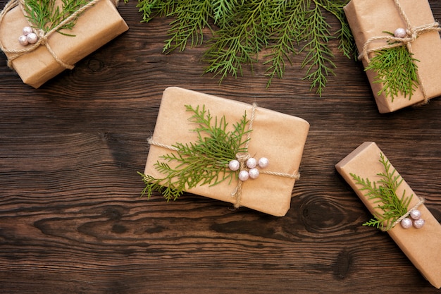 Christmas decorations and gift boxes on dark wooden board