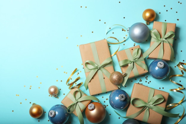 Christmas decorations and gifts on a colored background top view