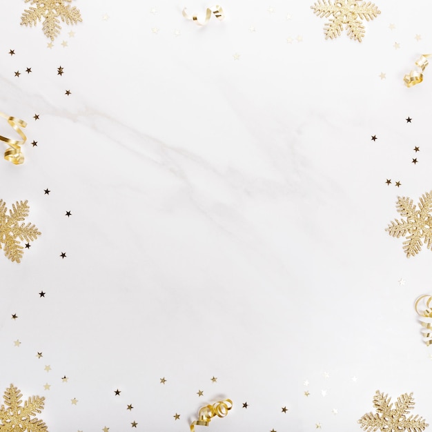 Christmas decorations in gold colors on white background Gift holiday and celebration concept top view