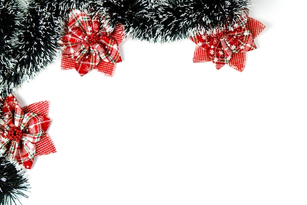 Christmas decorations and red bows on white background with copy space.