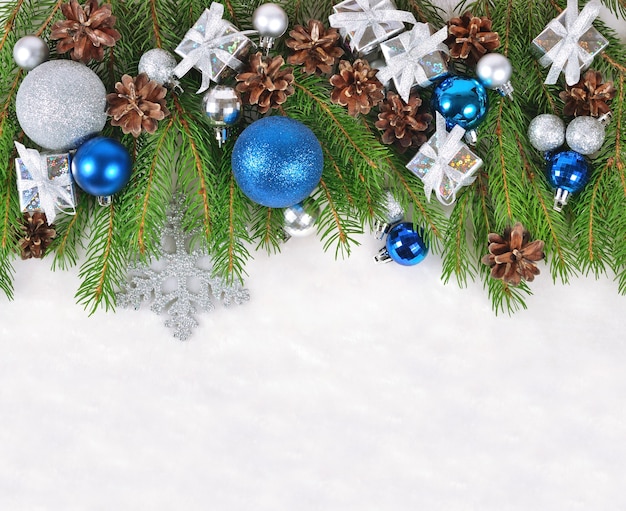 Christmas decorations on a spruce branch on a white background