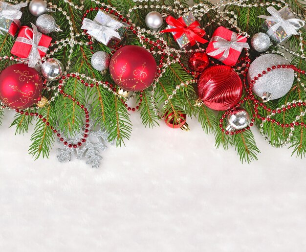 Christmas decorations on a spruce branch on a white background