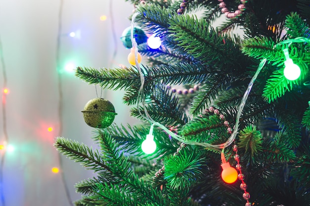 Christmas decorations and toys on artificial spruce, New Year atmosphere.