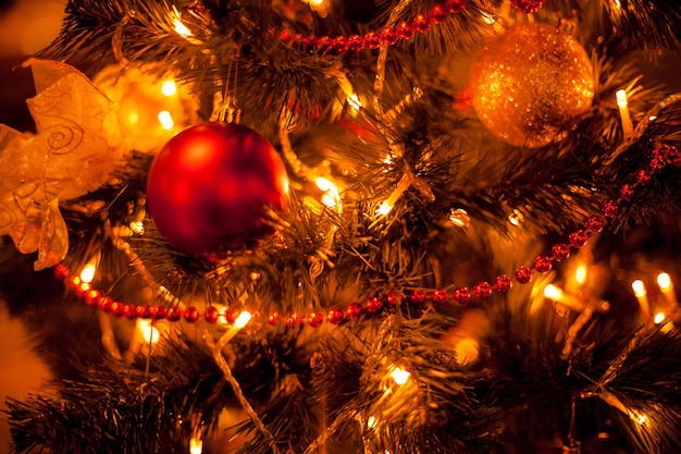 Christmas decorations on the tree Golden balls and garlands on the Christmas tree