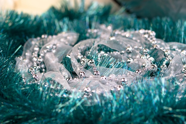 Christmas decorations of turquoise color Silver beads on the background of a mint garland