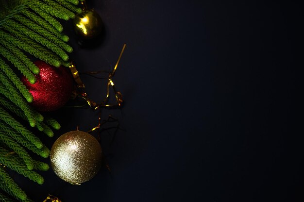 Christmas decorations with spheres gifts and pine needles with space for text and black background