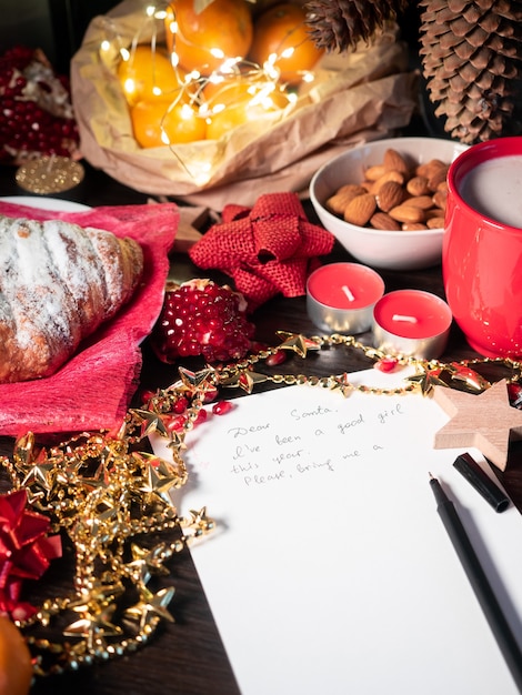 Christmas decorations with started letter to Santa on the table