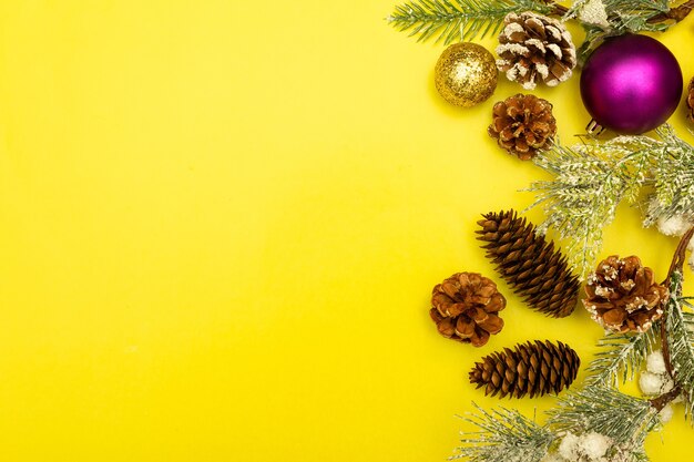 christmas decorations on yellow wooden table, flat lay