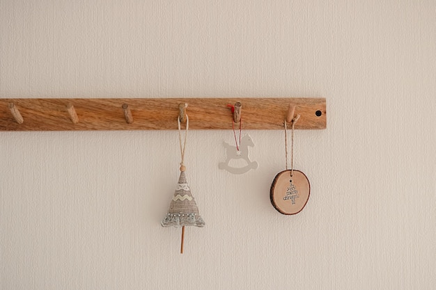 Christmas decorative handmade ornament hanging on a wood hook rack on white