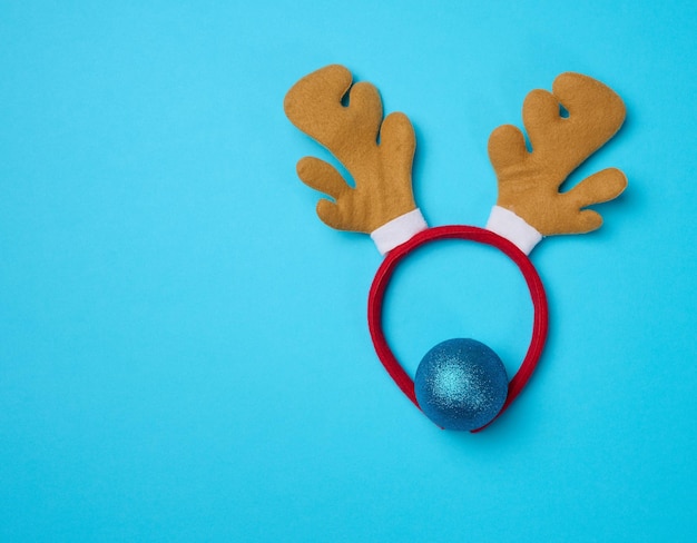 Christmas deer costume with antlers on the head on a blue background